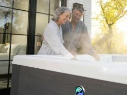 Hot Spring Aria - 5 Person Hot Tub 14 Hot Spring Aria - 5 Person Hot Tub -HAPPY HOT TUBS Shop hot spring highlife aria alpinewhite charcoal older couple touching water